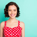 Close up portrait of fascinating young, beautiful wonderful lady posing in front of came while isolated with teal background