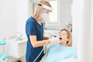 Young woman in dental clinic with female dentist.