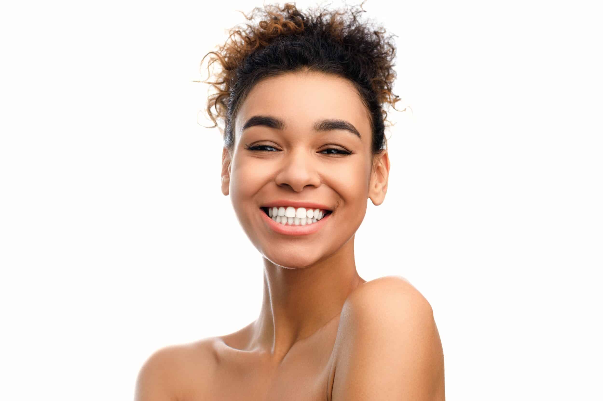 Woman shows beautiful teeth after undergoing cosmetic dentistry