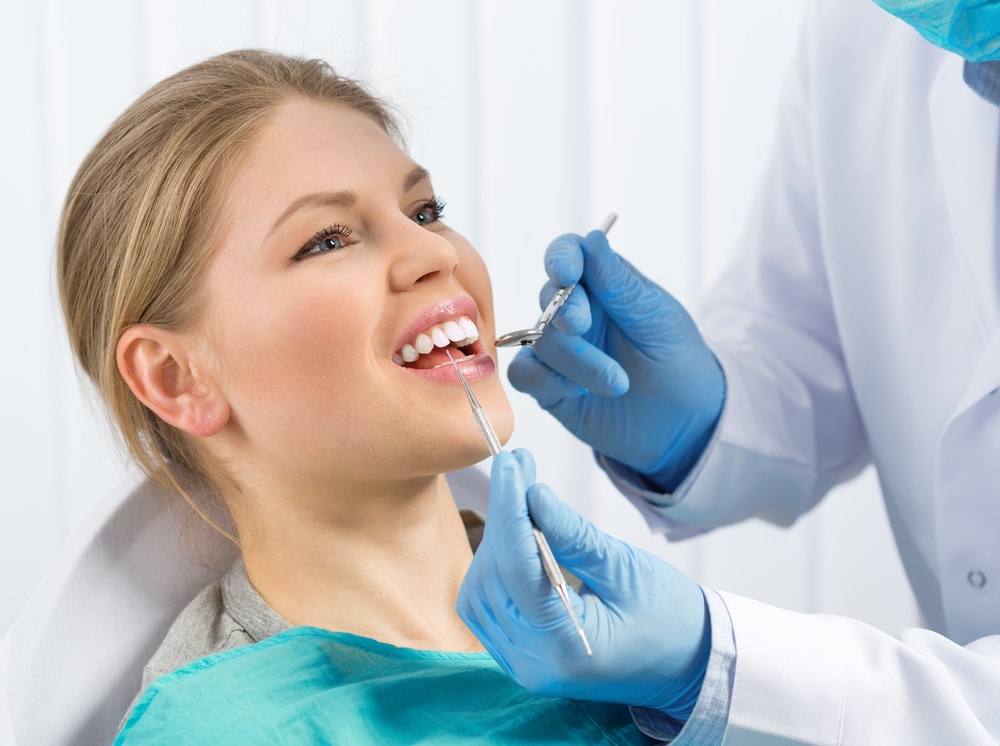 Calm patient is able to overcome her dental fears and undergo a routine examination by a dentist in NYC.